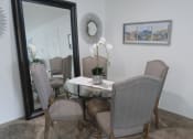 Thumbnail 6 of 19 - Elegant dining room with a large wall mirror and a table set for six