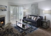Thumbnail 2 of 19 - Cozy living room with a sofa, coffee table, and fireplace
