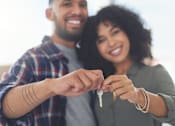 Thumbnail 52 of 55 - A man and woman holding keys together.