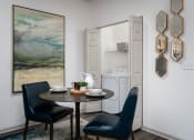 Thumbnail 7 of 25 - Dining nook with wooden table, two blue chairs, and nearby kitchen access at The Coleman in Canal Winchester, OH
