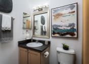Thumbnail 13 of 25 - Compact bathroom with a sink and toilet, styled in neutral tones