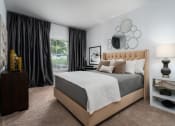 Thumbnail 2 of 25 - Cozy bedroom setup with bed, nightstand, and neutral tones at The Coleman Apartments