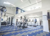 Thumbnail 16 of 25 - Fitness center at The Coleman with cardio equipment and open loft-style layout