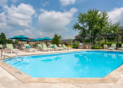 Thumbnail 19 of 25 - Refreshing swimming pool at The Coleman with ample lounge seating and umbrellas