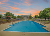 Thumbnail 4 of 23 - Florence, KY Apartments - Windridge Townhomes - Sparkling Pool with Lounge Chairs and Dining Areas Surrounded By Lush Landscaping