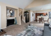 Thumbnail 3 of 23 - a living room with a fireplace and a glass coffee table