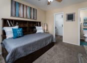 Thumbnail 11 of 23 - a bedroom with a bed and a ceiling fan