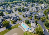 Thumbnail 23 of 23 - an aerial view of a neighborhood with a swimming pool and parking lot