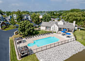 Thumbnail 21 of 23 - an aerial view of a pool and deck with a house in the background