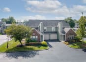 Thumbnail 5 of 23 - a large house with a driveway and trees in front of it