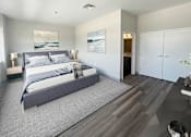 Thumbnail 15 of 19 - A bedroom with a large bed and a painting on the wall.