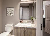 Thumbnail 4 of 14 - A bathroom with a toilet, sink, and mirror.
