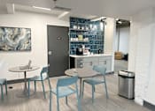 Thumbnail 18 of 19 - A modern kitchen with blue chairs and a table.