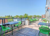 Thumbnail 22 of 31 - the patio of a building with tables and chairs and a view of a body of water