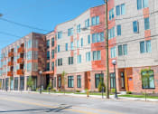 Thumbnail 29 of 31 - a picture of a large apartment building on a city street