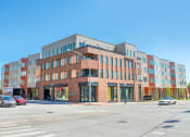 Thumbnail 31 of 31 - a large brick building with many windows and a street in front of it