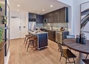 Thumbnail 54 of 60 - a kitchen and dining area with a table and chairs