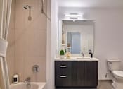 Thumbnail 52 of 60 - a bathroom with a sink toilet and a shower