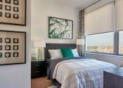 Thumbnail 54 of 61 - a bedroom with a bed and a large window