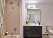 Thumbnail 48 of 61 - a bathroom with a sink toilet and a shower
