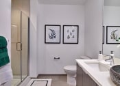 Thumbnail 55 of 61 - a bathroom with a toilet and a sink and a shower