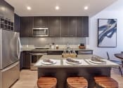Thumbnail 1 of 61 - a kitchen with a counter top and a refrigerator