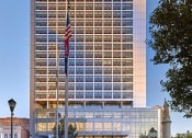 Thumbnail 49 of 61 - an flag in front of a tall building