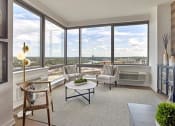Thumbnail 53 of 61 - a living room with a view of a city and a table and chairs