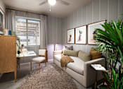 Thumbnail 16 of 22 - A living room with a couch, chair, and a cabinet.