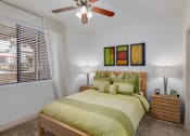 Thumbnail 19 of 29 - A bedroom with a bed, nightstand, and a ceiling fan.