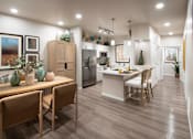 Thumbnail 17 of 22 - A modern kitchen with wooden chairs and a dining table.