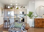 Thumbnail 3 of 11 - A modern kitchen with a zebra print chair in the foreground.