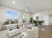 Thumbnail 5 of 14 - A modern living room with a white sofa, a coffee table, and a dining table set up.