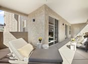 Thumbnail 4 of 11 - A modern living room with a white sofa and a grey cushion.