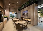 Thumbnail 6 of 22 - A modern dining room with a long table and chairs.
