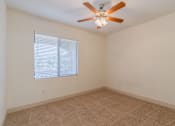 Thumbnail 23 of 24 - A room with a ceiling fan and a window with blinds.