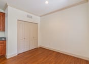 Thumbnail 21 of 24 - A room with a wooden floor and a white door.