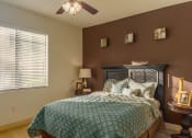Thumbnail 41 of 51 - a bedroom with a bed and a ceiling fan