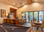 Thumbnail 32 of 51 - a game room with a pool table and a bar