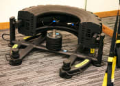 Thumbnail 31 of 51 - a small mechanical device with a wheel and axle on the floor