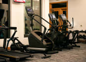 Thumbnail 27 of 51 - a row of exercise machines in a gym