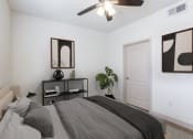 Thumbnail 10 of 51 - a bedroom with a large bed and a ceiling fan