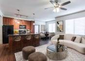 Thumbnail 12 of 51 - a living room and kitchen with wood cabinets and a white couch