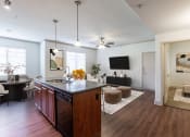 Thumbnail 14 of 51 - a kitchen and living room with hardwood floors and a ceiling fan