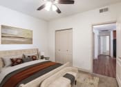 Thumbnail 18 of 51 - a bedroom with a large bed and a ceiling fan