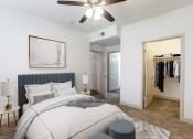 Thumbnail 16 of 51 - a bedroom with a large bed and a ceiling fan