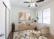 Thumbnail 23 of 51 - a living room with a ceiling fan and a door to a bedroom