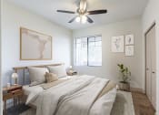 Thumbnail 22 of 51 - a bedroom with a ceiling fan and a window