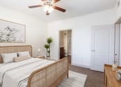 Thumbnail 24 of 51 - a bedroom with a bed and a ceiling fan