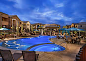 Thumbnail 1 of 23 - A luxury apartment swimming pool with shallow end loungers